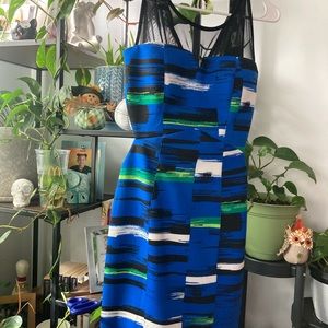 Body con pattern dress with side cut outs. Mesh on top.